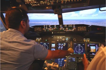a man standing in front of a computer