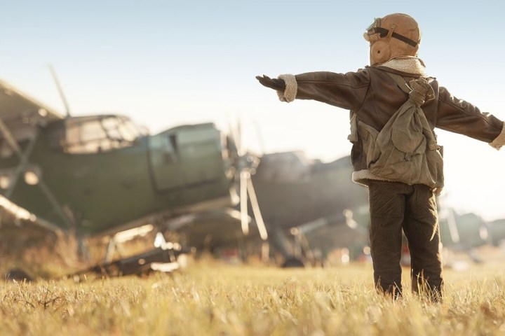 a person standing on top of a grass covered field