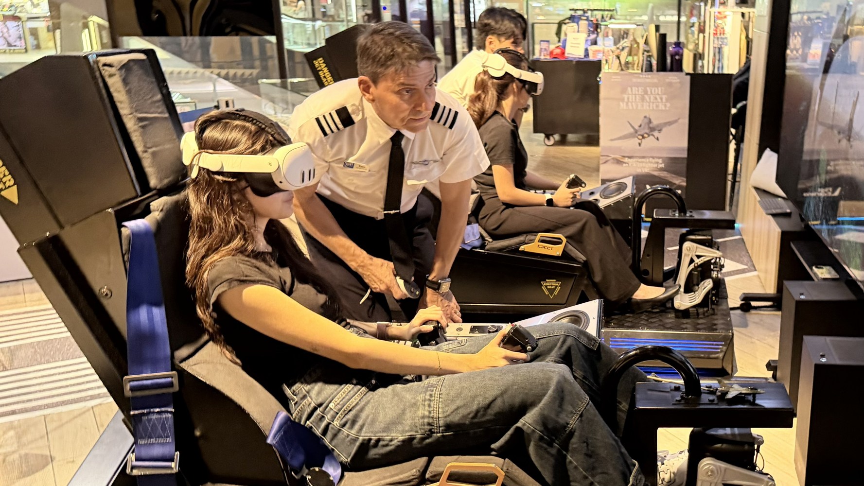 People using flight simulators with VR headsets, guided by an instructor in a pilot uniform.
